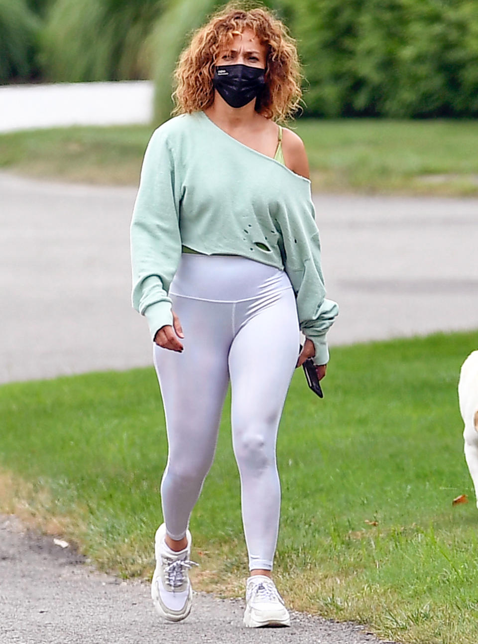 <p>Jennifer Lopez goes for a walk in Water Mill, New York, on Wednesday wearing a green sweater and white tights.</p>