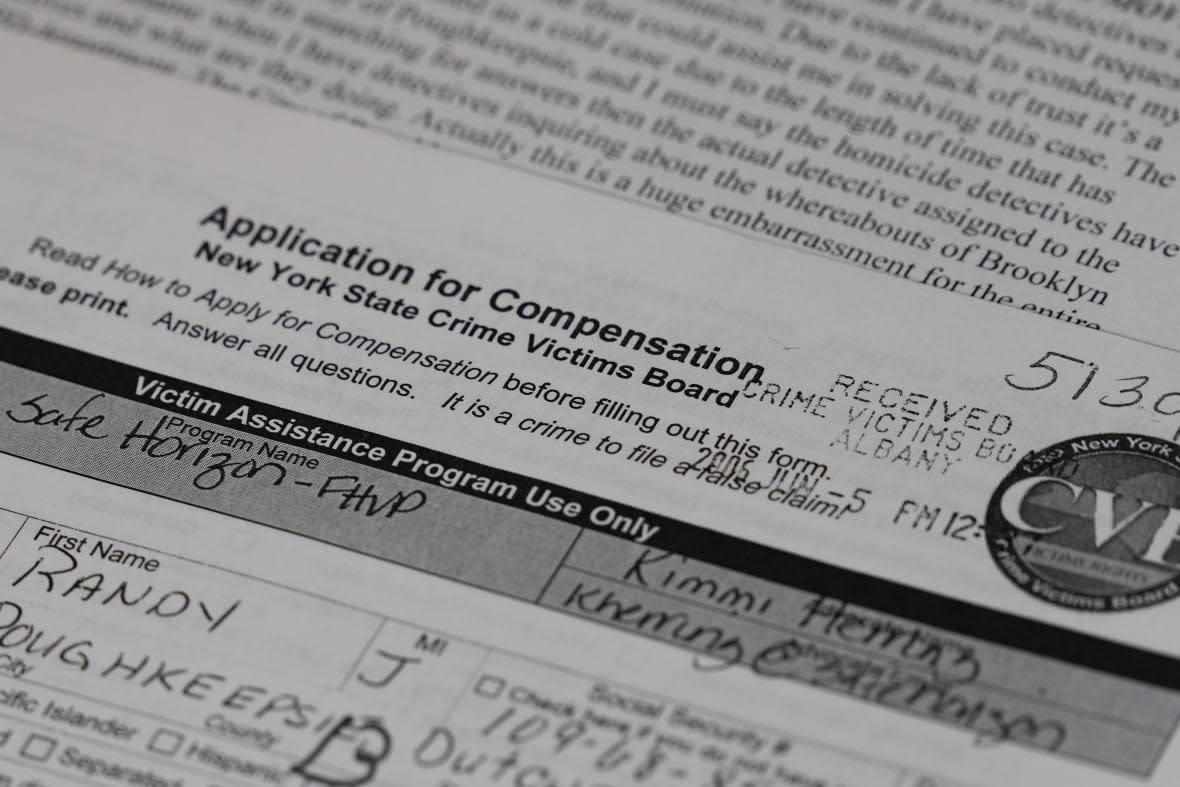 Paperwork and letters relating to the case of Randy Long, who was murdered in 2006, are shown by his mother, Debra Long, in Poughkeepsie, N.Y., April 19, 2023. An AP examination of data from 23 states shows that Black people are disproportionately denied aid from programs that reimburse victims of violent crime. (AP Photo/Seth Wenig)