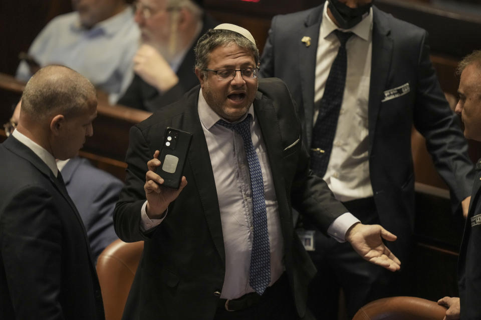 FILE - Lawmaker Itamar Ben-Gvir is taken from the plenum before the vote on a bill to dissolve parliament, at the Knesset, Israel's parliament, in Jerusalem, Thursday, June 30, 2022. Ben-Gvir, an ultranationalist lawmaker who was once relegated to the margins of Israeli politics, is surging in the polls ahead of November’s parliamentary elections. (AP Photo/Ariel Schalit, File)