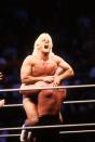 <p>Road Warrior Hawk squeezes the “Nature Boy” Rick Flair during their Heavy Weight bout at the 1988 Bunkhouse Stampede on January 24, 1988 at the Nassau Coliseum in Uniondale, New York. (Photo by B Bennett/Getty Images) </p>