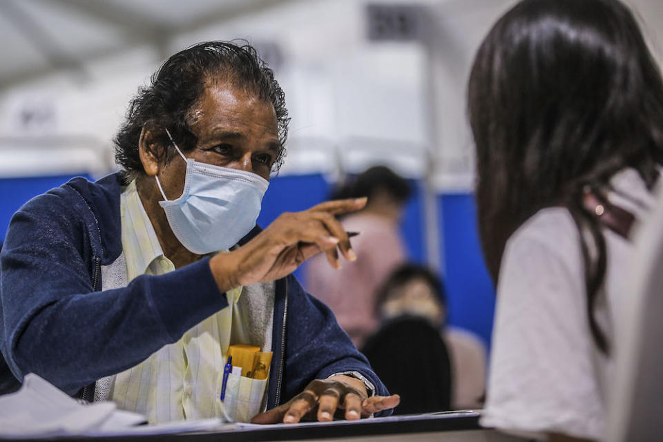 Volunteer M. Selvarajan is pictured at the vaccination centre (PPV) in Bukit Jalil June 27, 2021. ―  Picture by Hari Anggara