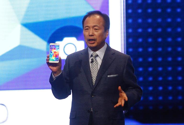 JK Shin, head of Samsung Mobile Communications, presents a Galaxy S5 smartphone during a press conference at the Mobile World Congress in Barcelona, on February 24, 2014