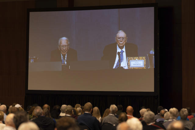 Shareholders watch Warren Buffett and Charlie Munger from the overflow room during the Berkshire Hathaway annual meeting on Saturday, May 6, 2023, in Omaha, Neb. (AP Photo/Rebecca S. Gratz)
