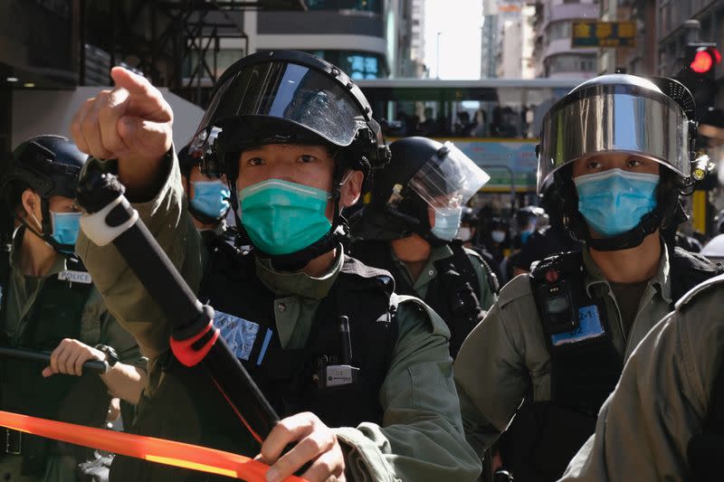 Riot police ask people to leave to avoid mass gathering during a protest against the looming national security legislation in Hong Kong