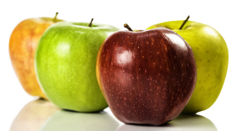 Different colored apples on white background 