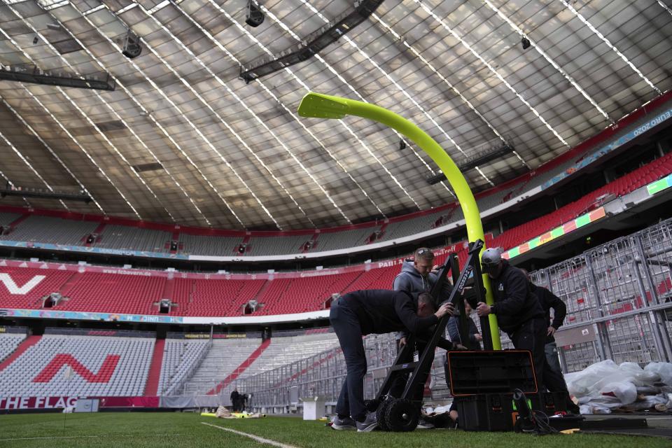 Workers prepare a goal inside the FC Bayern Munich soccer stadium Allianz Arena in Munich, Germany, Wednesday, Nov. 9, 2022. The Tampa Bay Buccaneers are set to play the Seattle Seahawks in an NFL game at the Allianz Arena in Munich on Sunday. (AP Photo/Matthias Schrader)