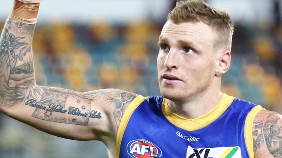 Brisbane's Mitch Robinson is pictured waving his hand as he walks from the fiend after an AFL match.