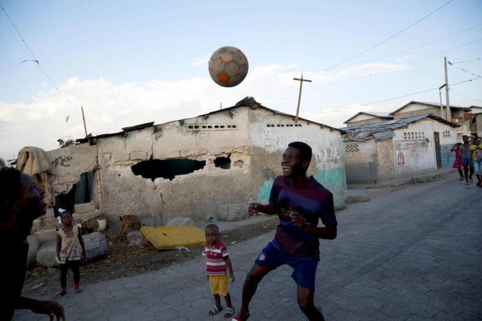 Youths play soccer in the Cite Soleil slum of Port-au-Prince, Haiti, on Feb. 11, 2020. At the time, the economy appeared to be shrinking and electricity was provided only a few hours a day in most of the capital.