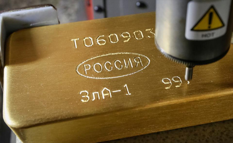 A machine engraves information on an ingot of 99.99 percent pure gold at the Krastsvetmet non-ferrous metals plant in the Siberian city of Krasnoyarsk