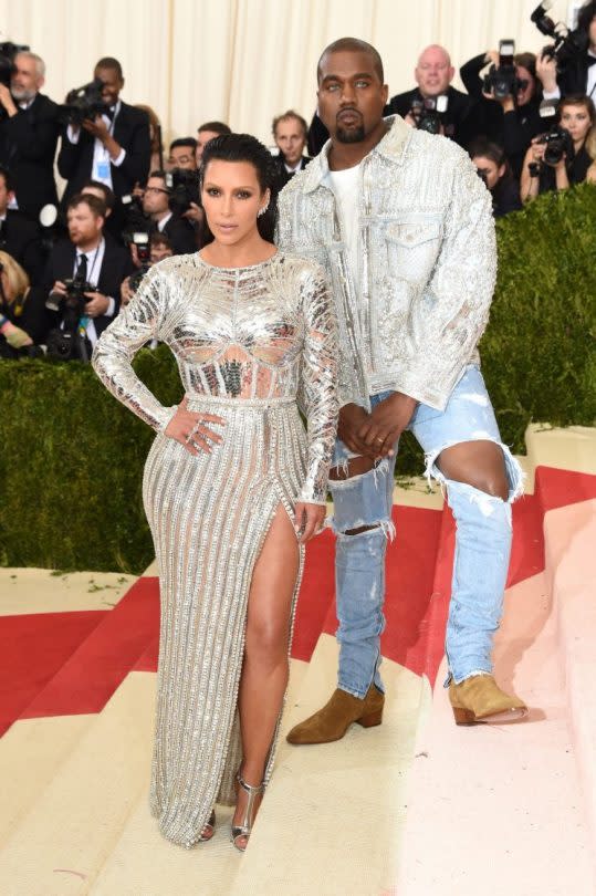 Kim Kardashian and Kanye West posing on the red carpet. (Photo: Getty Images)