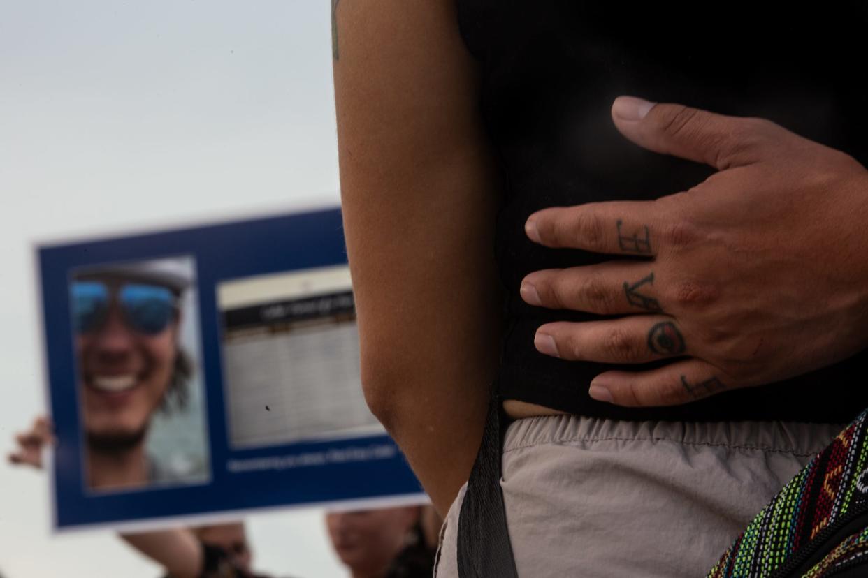 Jonathan Sanchez holds Elora Garcia during a vigil for Caleb Harris on Saturday, July, 20, 2024, in Corpus Christi, Texas. Harris, a 21-year-old Texas A&M University-Corpus Christi student went missing from his off-campus apartment in March. His body was recovered from a wastewater plant last month.