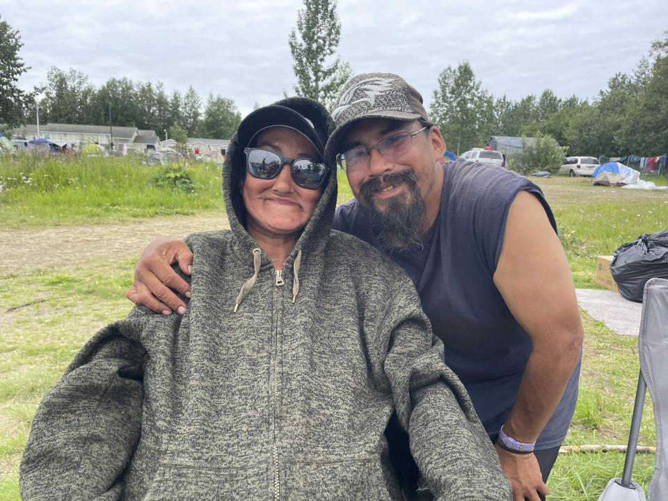 Clarita Clark and Philip Gregory pose for a photo Wednesday, July, 26, 2023, near downtown Anchorage, Alaska. They said they would fly home to Point Hope, Alaska, if Anchorage Mayor Dave Bronson's plan goes forward to buy homeless people plane tickets out of the state or to other Alaska cities to avoid the frigid winter temperatures instead of standing up Anchorage's sports arena as a mass shelter. (AP Photo/Mark Thiessen)