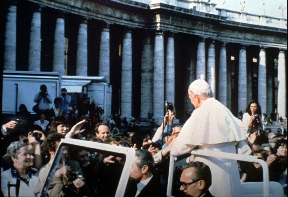 In this May 13, 1981 file photo provided by Vatican paper L'Osservatore Romano, Mehmet Ali Agca, left, holds a Browning HP 9mm handgun to shoot Pope Jonh Paul II at the Vatican. Alitalia Flight 488 landed in Krakow, Poland on Tuesday, March 18, 2014 with some very special cargo on board: The gun used to shoot Pope John Paul II. Monsignor Dariusz Ras, the Polish priest who runs the John Paul II museum in the late pope's childhood home in Wadowice, transported the pistol from Rome to Poland for the museum's upcoming exhibit in honor of John Paul's April 27 canonization, Alitalia said. Mehmet Ali Agca used the Browning HP 9mm handgun to shoot John Paul in the abdomen in St. Peter's Square on May 13, 1981. The pope spent nearly three weeks in the hospital recovering. (AP Photo/L'Osservatore Romano)