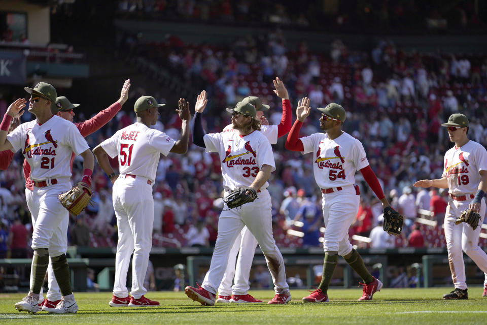 Members of the St. Louis Cardinals celebrate a 10-5 victory over the Los Angeles Dodgers in a baseball game Sunday, May 21, 2023, in St. Louis. (AP Photo/Jeff Roberson)