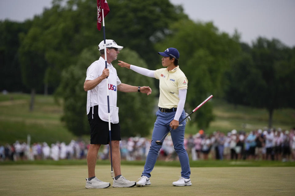 Yuka Saso, of Japan, congratulates her caddy after finishing on the 18th green during the final round of the U.S. Women's Open golf tournament at Lancaster Country Club, Sunday, June 2, 2024, in Lancaster, Pa. (AP Photo/Matt Slocum)