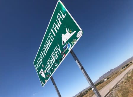 A sign reading "Extraterrestrial Highway" stands along the road in Rachel, Nevada