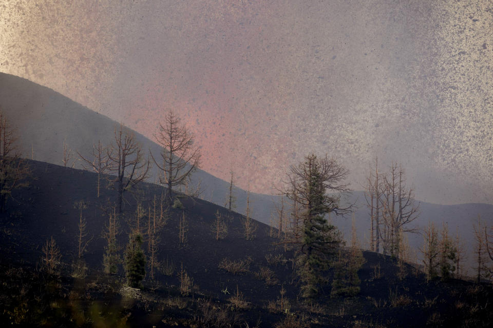 Lava flows from an eruption of a volcano near El Paso on the island of La Palma in the Canaries, Spain, of Monday, Sept. 20, 2021. Lava continues to flow slowly from a volcano that erupted in Spain's Canary Islands off northwest Africa. The head of the islands' regional government says Monday he expects no injuries to people in the area after some 5,000 were evacuated. (AP Photo/Gerardo Ojeda)