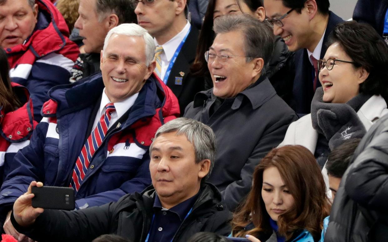Mike Pence and South Korean President Moon Jae-in laugh during the ladies' 500 meters short-track speedskating in the Gangneung Ice Arena at the 2018 Winter Olympics in Gangneung, South Korea  - AP