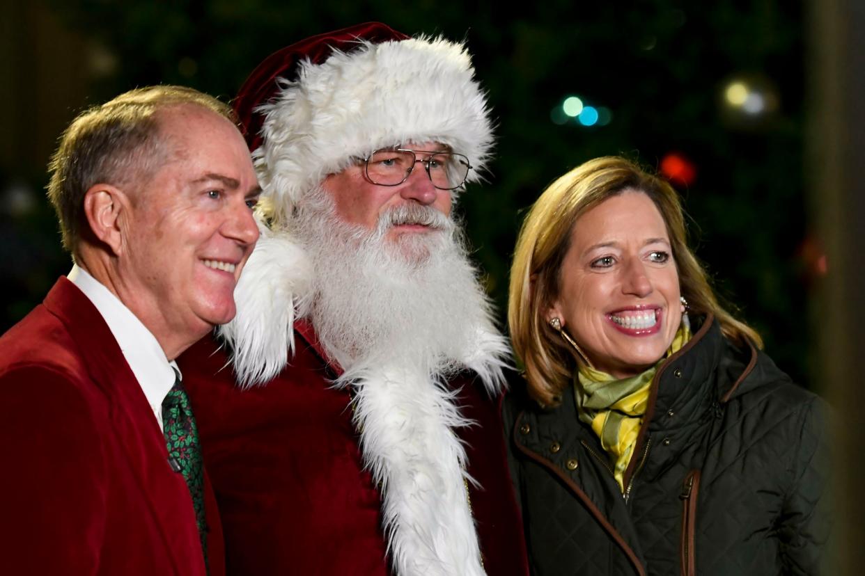 Santa poses for a photo with Greenville Mayor Knox White and city councilwoman Dorothy Dowe before the tree lighting begins in front of M. Judson Booksellers on Main Street on Friday, Dec. 1, 2023. Greenville's annual Night of Lights event was cancelled due to weather.