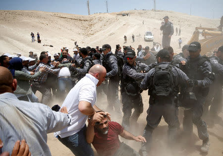 Israeli policemen scuffle with Palestinians in the Bedouin village of al-Khan al-Ahmar near Jericho in the occupied West Bank July 4, 2018. REUTERS/Mohamad Torokman