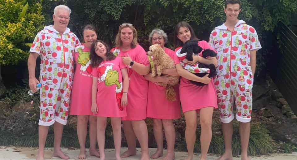 Rhani (second left) and Keira (front) and with Aisling (second right) and parents, grandmother and brother wearing matching Grinch Christmas pyjamas.