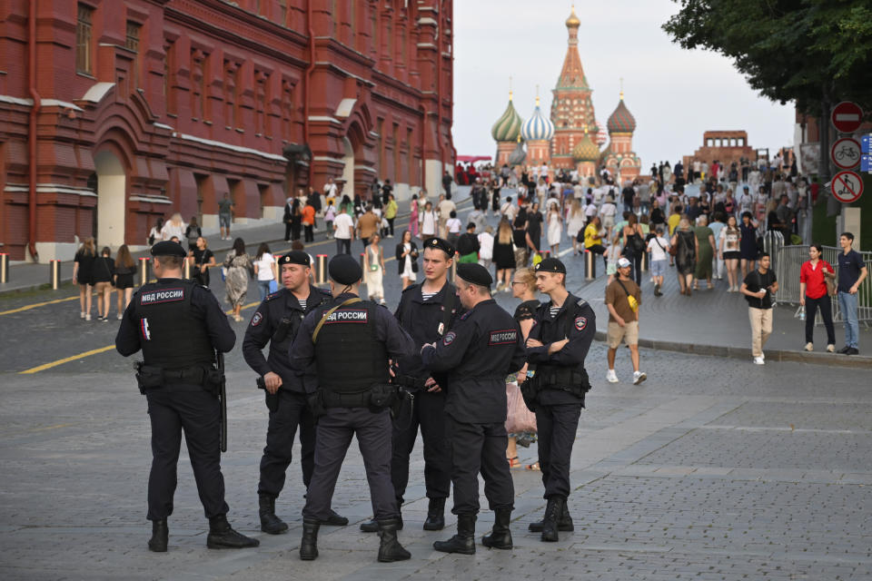 Police officers stand near the Red Square in Moscow, Russia, Tuesday, Aug. 1, 2023. The glittering towers of the Moscow City business district were once symbols of the Russian capital's economic boom in the early 2000s. Now they are a sign of its vulnerability, following a series of drone attacks that rattled some Muscovites shaken and brought the war in Ukraine home to the seat of Russian power. (AP Photo/Dmitry Serebryakov)