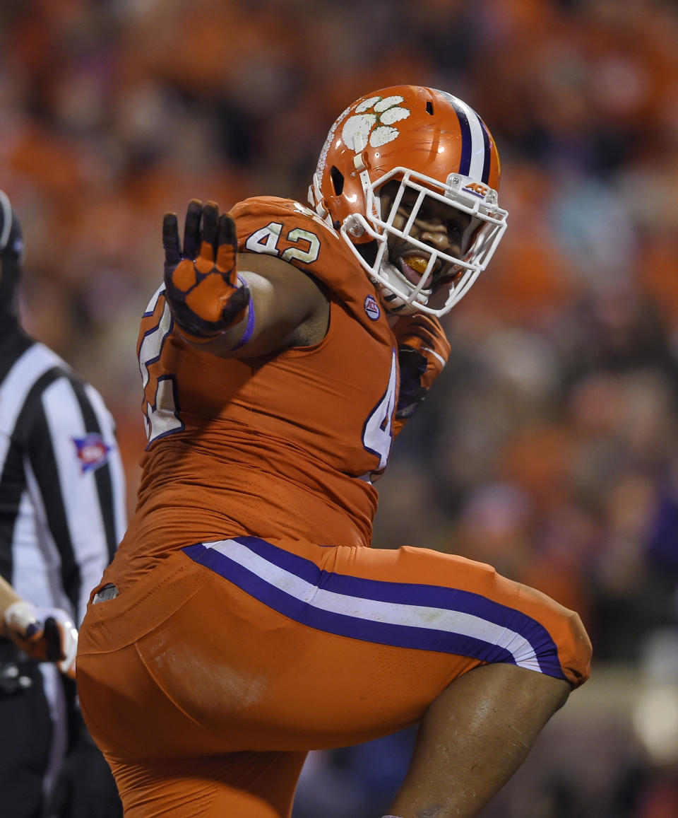 FILE - In this Nov. 24, 2018, file photo, Clemson tackle Christian Wilkins does the Heisman pose after scoring a touchdown during the first half of a game against South Carolina, in Clemson, S.C. Wilkins was named to the 2018 AP All-America NCAA college football team, Monday, Dec. 10, 2018.(AP Photo/Richard Shiro, File)