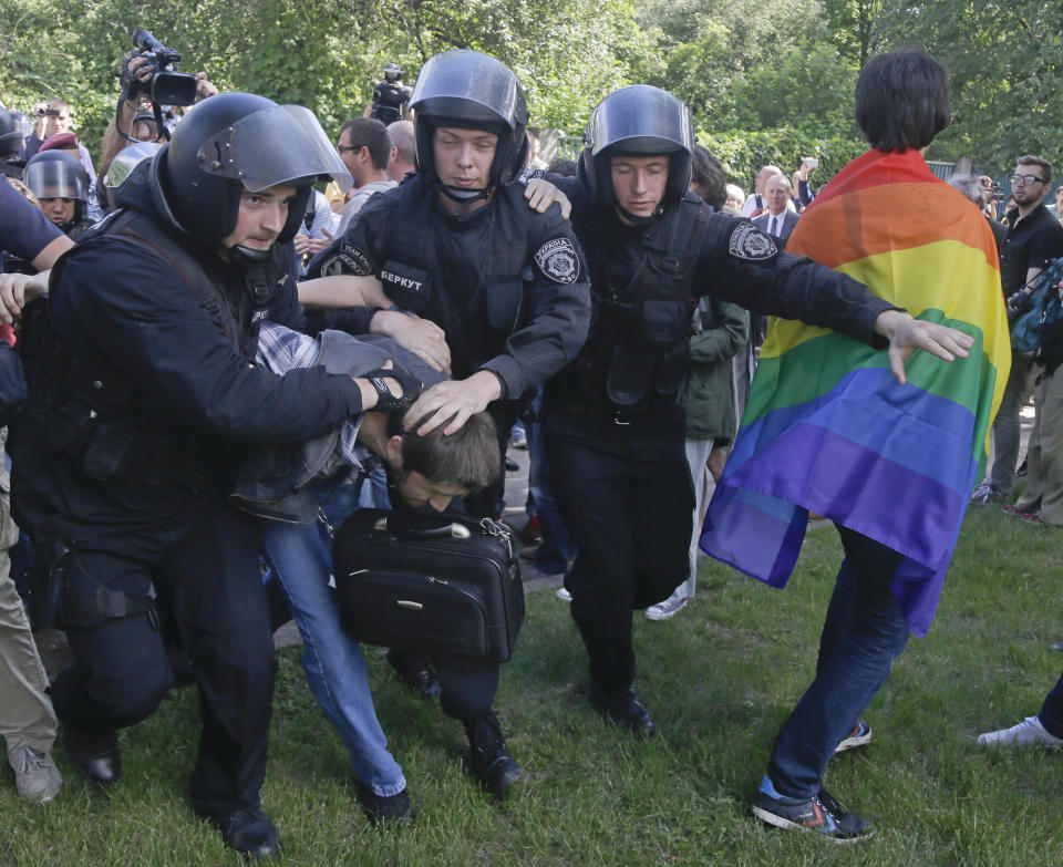FILE - Riot police detain a protester who is trying to stop Ukraine's first gay pride demonstration in Kyiv, Ukraine, Saturday, May 25, 2013. Despite the war in Ukraine, the country's largest LGBT rights event, KyivPride, is going ahead on Saturday, June 25, 2022. But not on its native streets and not as a celebration of gay pride. It will instead join Warsaw's yearly Equality Parade, using it as a platform to keep international attention focused on the Ukrainian struggle for freedom. (AP Photo/Efrem Lukatsky, File)