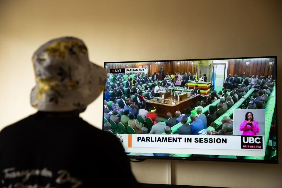 A Ugandan transgender woman who was recently attacked and currently being sheltered watches a TV screen showing the live broadcast of the session from the Parliament for the anti-gay bill, at a local charity supporting the LGBTQ Community near Kampala on March 21, 2023. - Uganda&#39;s parliament was due to vote on March 21, 2023 on anti-gay legislation which proposes tough new penalties for same-sex relations in a country where homosexuality is already illegal.
Under the proposed law, anyone in the conservative East African nation who engages in same-sex activity or who identifies publicly as LGBTQ could face up to 10 years in prison. (Photo by STUART TIBAWESWA / AFP) (Photo by STUART TIBAWESWA/AFP via Getty Images)