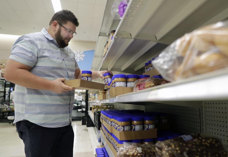 Executive Director Ryan Rasmussen stocks shelves at the Oshkosh Area Community Pantry on Wednesday, Sept. 28, 2022, in Oshkosh, Wis.