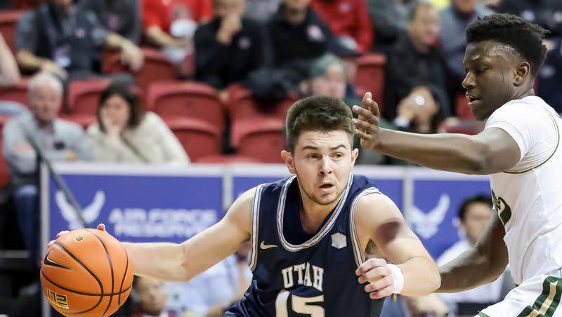 Utah State Aggies guard Rylan Jones (15) drives around Colorado State Rams guard Isaiah Stevens (4) during a Mountain West tournament quarterfinal at the Thomas & Mack Center in Las Vegas on Thursday, March 10, 2022.