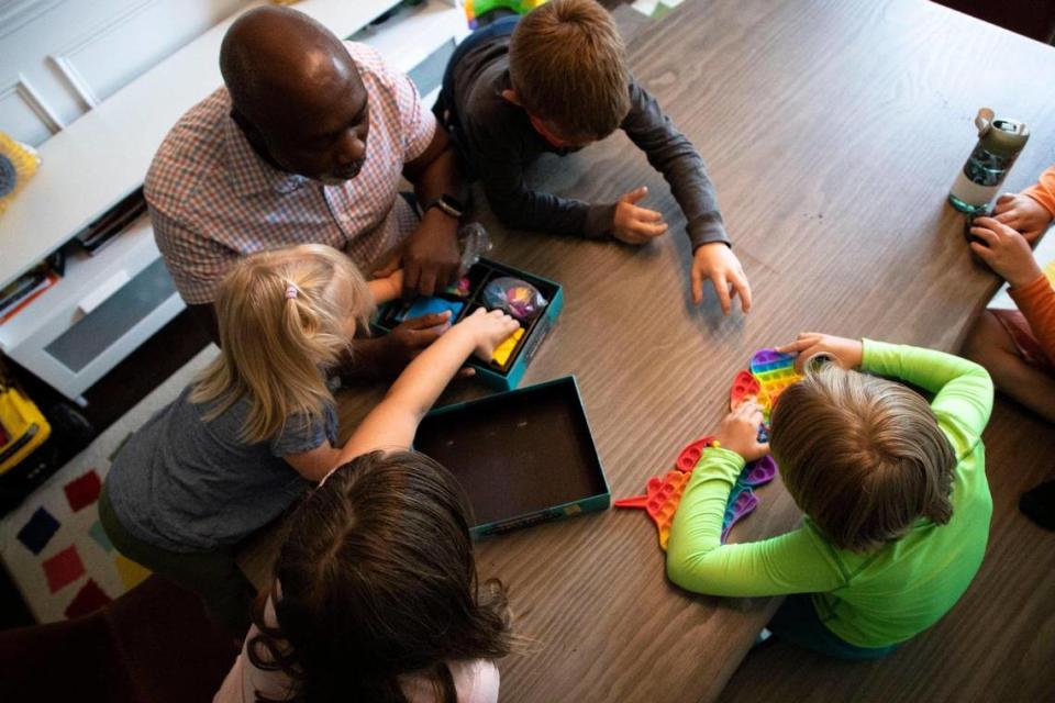 Peter Mutabazi plays a game with all five of his foster children on Wednesday, June 5, 2023 at his Charlotte home. Mutabazi has had 34 foster kids since he started fostering children.