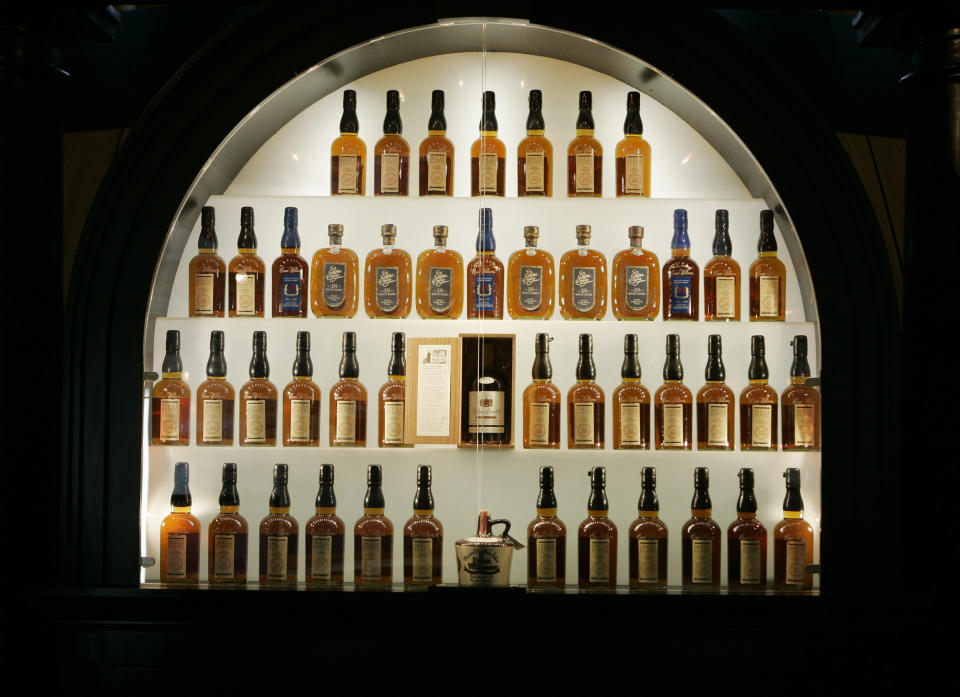 FILE- In this April 8, 2009, file photo, bottles of bourbon are shown in a display case at the Heaven Hill Bourbon Heritage Center in Bardstown, Ky. Heaven Hill, one of the world's largest bourbon producers, announced a tentative contract deal Friday, Oct. 22, 2021, with striking union workers, just days after signaling it intended to start hiring permanent replacement employees for bottling and warehouse operations in Kentucky.(AP Photo/Ed Reinke, File)