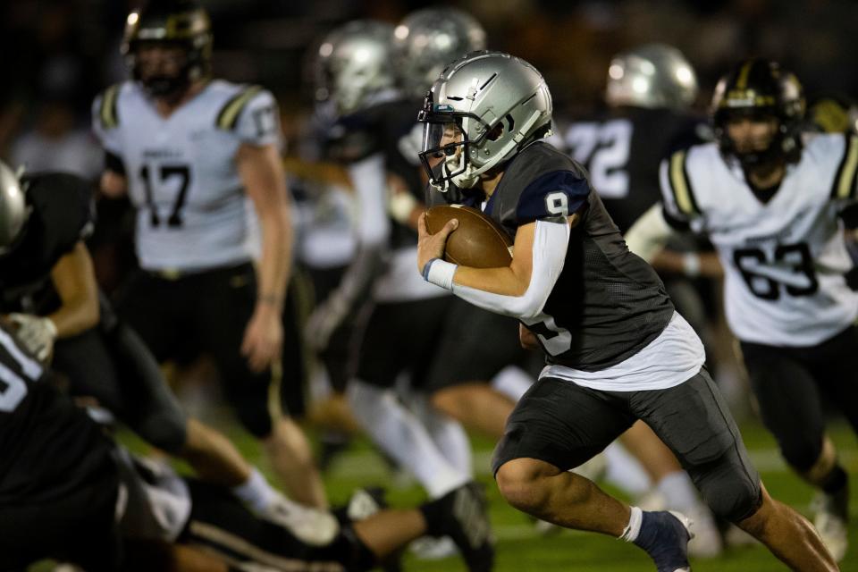 Reitz’s Roland Vera Jr. (9) runs the ball as the Reitz Panthers play the Boonville Pioneers at the Reitz Bowl in Evansville, Ind., Friday, Oct. 20, 2023.