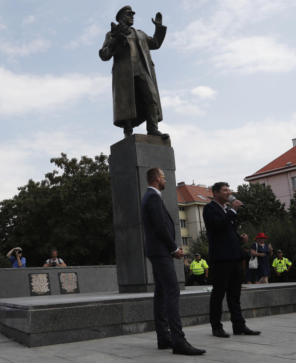 In this file picture taken on Tuesday, Aug. 21, 2018, Prague 6 district representatives unveil a new explanatory text about the role of Soviet World War II commander Ivan Stepanovic Konev at his monument in Prague, Czech Republic. A Prague district is set to remove a statue of a Soviet World War II commander Ivan Konev from its site, a move that will likely anger Russia. After it was targeted by vandals, Prague 6 approved Thursday, Sept. 12, 2019 a plan to remove it. (AP Photo/Petr David Josek/File)