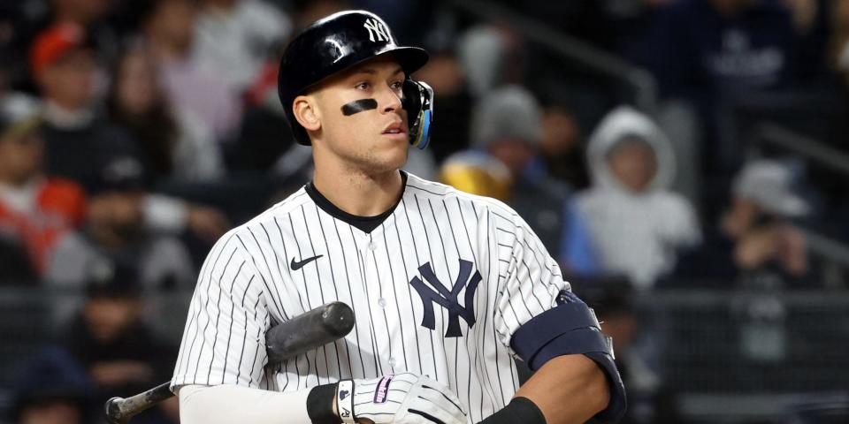 Aaron Judge holds the bat and adjusts his gloves during an at-bat against the Astros in 2022.