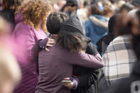 A parent hugs a student as they are reunited after a school shooting at East High School Wednesday, March 22, 2023, in Denver. Two school administrators were shot at the high school Wednesday morning after a handgun was found on a student subjected to daily searches, authorities said. (AP Photo/David Zalubowski)