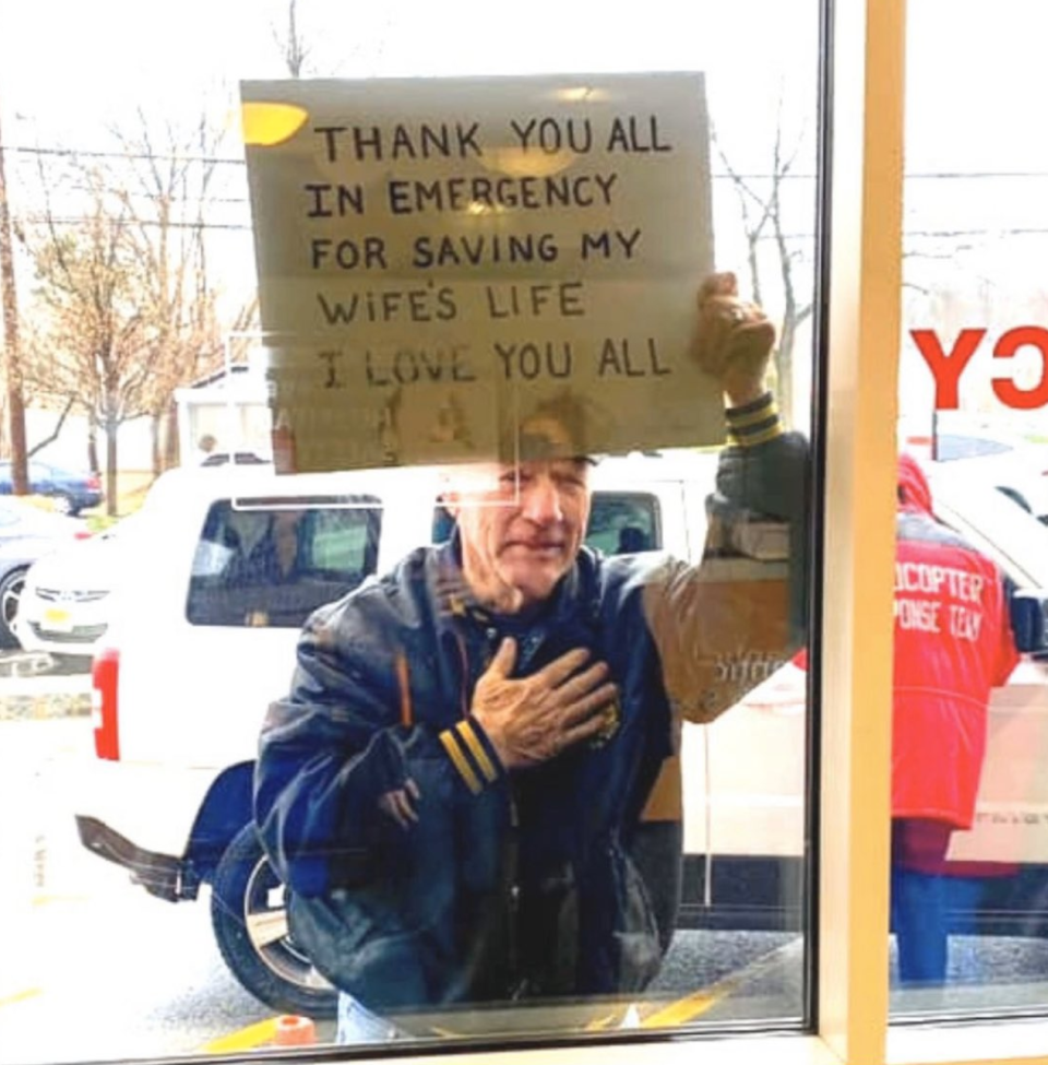 The man is seen holding the sign through the window. Source: Allison S.