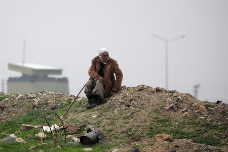 An elderly man sits near the Syrian-Turkish border in Ras al-Ayn town, Syria December 20, 2018. REUTERS/Rodi Said