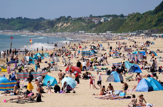 People enjoying the warm weather at Bournemouth beach in Dorset.