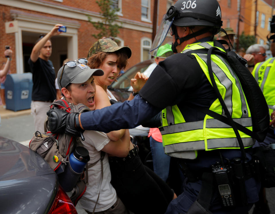 <p>Police detain a protester at the site where Heather Heyer was killed, on the one year anniversary of the 2017 Charlottesville “Unite the Right” protests, in Charlottesville, Virginia, U.S., August 12, 2018. REUTERS/Brian Snyder – RC1D004F6340 </p>