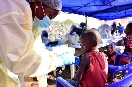 A Congolese health worker administers ebola vaccine to a child at the Himbi Health Centre in Goma