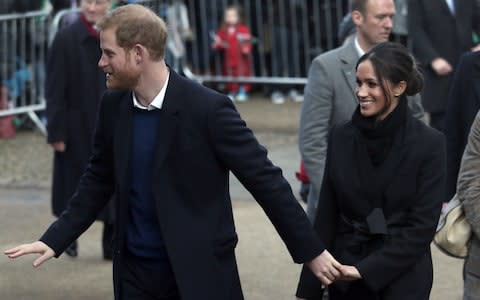 The couple smile as they arrive in Cardiff after a delayed journey - Credit: Aaron Chown /PA