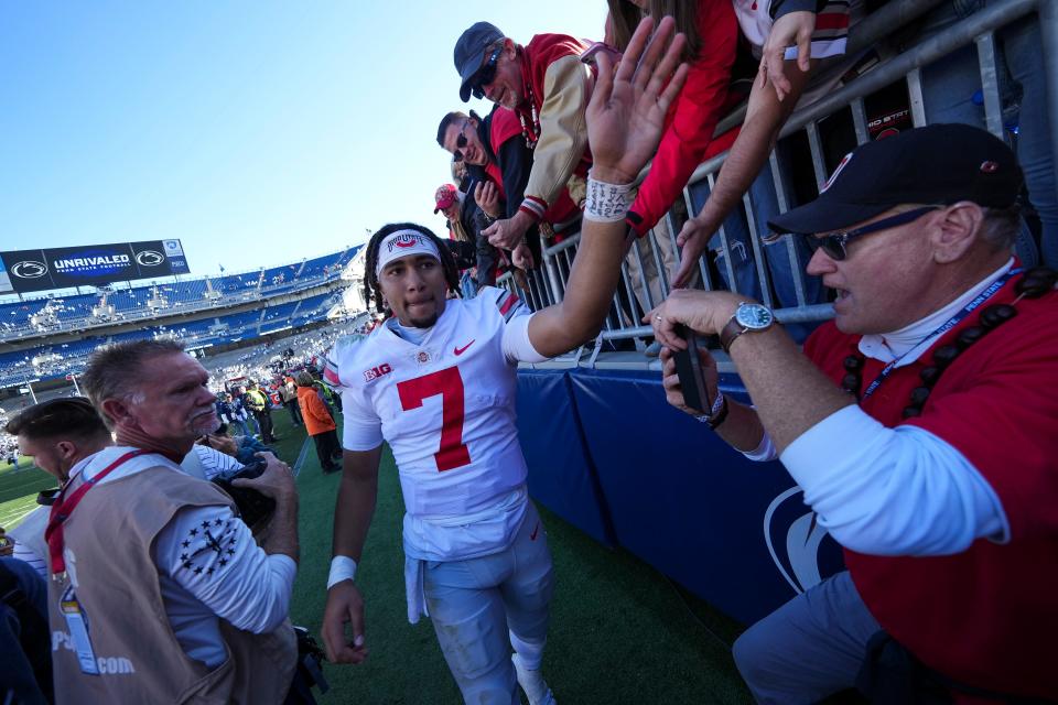 Oct 29, 2022; University Park, Pennsylvania, USA; Ohio State Buckeyes quarterback C.J. Stroud (7) gets high fives as he leaves the field following the NCAA Division I football game against the Penn State Nittany Lions at Beaver Stadium. Ohio State won 41-33. Mandatory Credit: Adam Cairns-The Columbus Dispatch