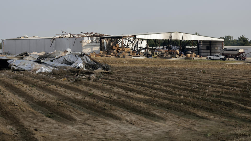 Debris litters the ground near an agricultural building significantly damaged by a tornado on Wednesday, July 19, 2023, in Rocky Mount, N.C. (AP Photo/Chris Seward)