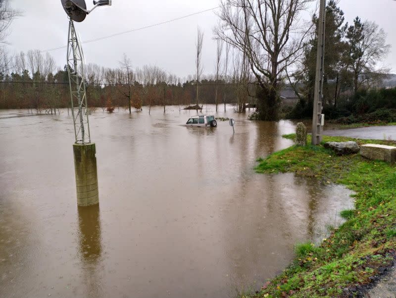 A car sits in floodwater after Storm Elsa swept throughout Galicia, in the province of Ourense