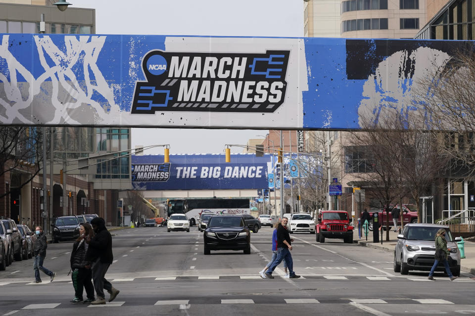 March Madness banners for the NCAA college basketball tournament cover crosswalks in downtown Indianapolis, Wednesday, March 17, 2021. (AP Photo/Darron Cummings)