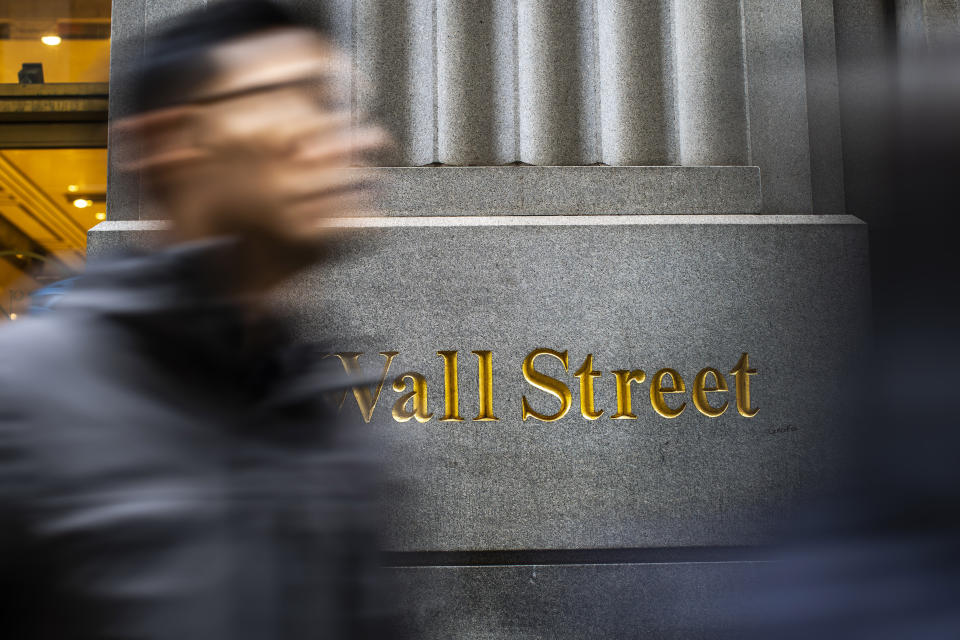 FILE - People walk by the New York Stock Exchange in New York, Tuesday, March 19, 2024. (AP Photo/Eduardo Munoz Alvarez, File)