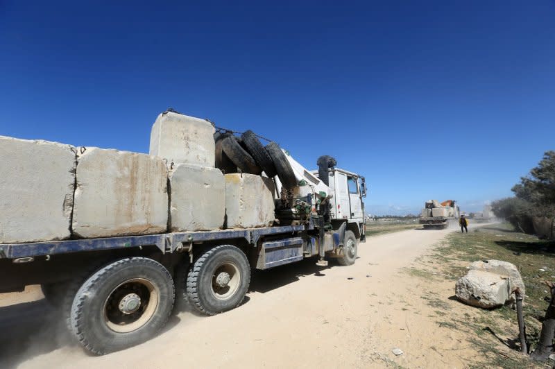 Construction equipment is loaded Friday with stone blocks from Khan Younis, Gaza, to be used to build at temporary port to facilitate the delivery of humanitarian aid by sea. Photo by Ahmed Abd/UPI