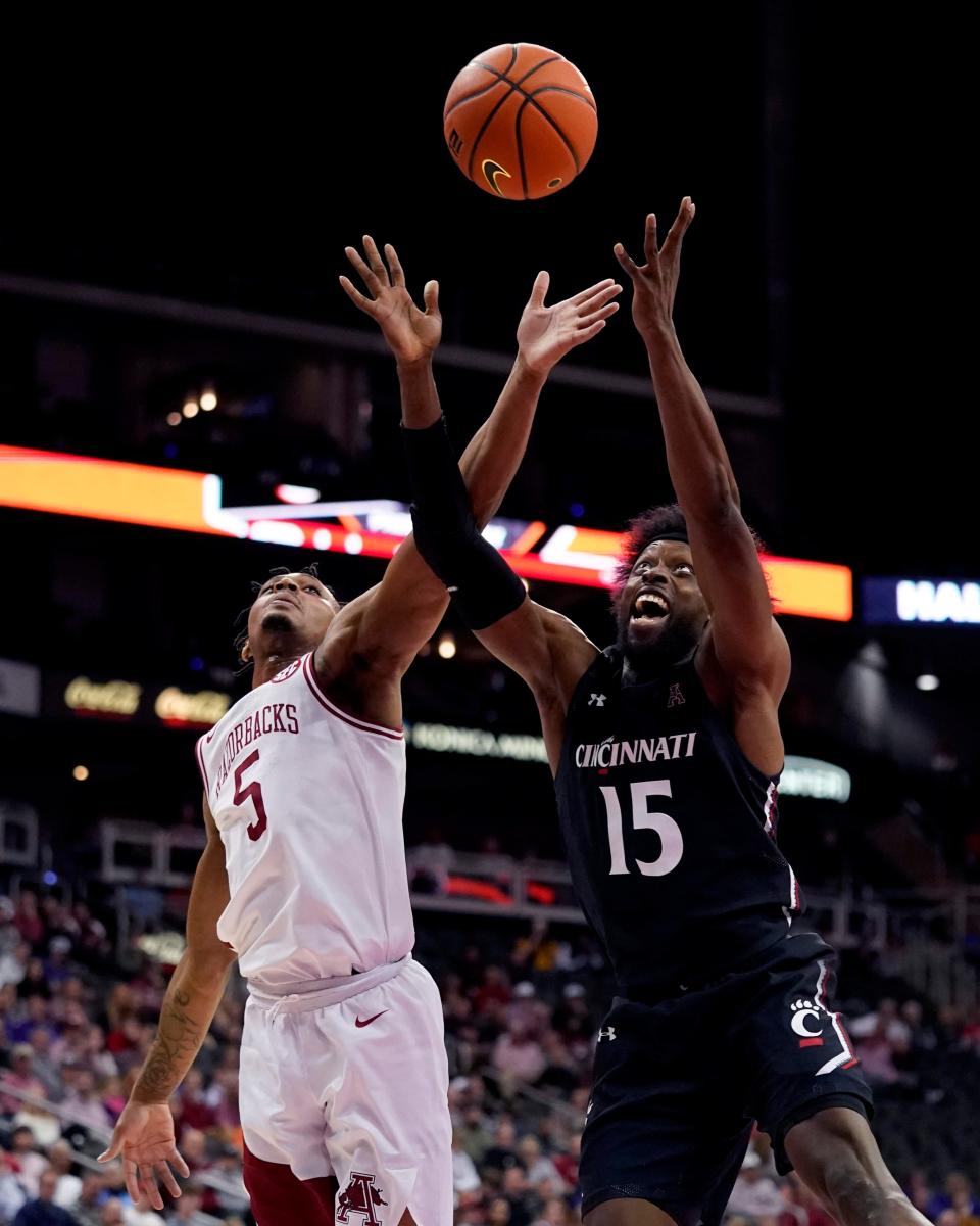 Arkansas' Au'Diese Toney (5) and Cincinnati's John Newman III (15) battle for a rebound during the first half of an NCAA college basketball game Tuesday, Nov. 23, 2021, in Kansas City, Mo.